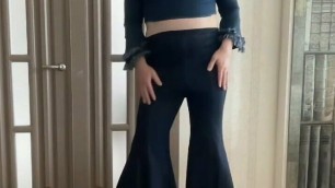 Crossdresser gay tranny in wide leg bootcut flare jeans and crop top and high heels dancing for his master and mistress