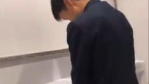 A male student is pissing in the toilet 9.